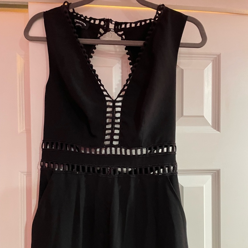 Bebe, size 8 black slim jumpsuit with cut outs